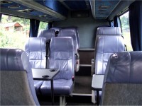 Tables and aircraft style lockers over the seating available in this 12-seater minibus. MInibus hire from Sweeneys of Muthill, Perthshire, Scotland, UK